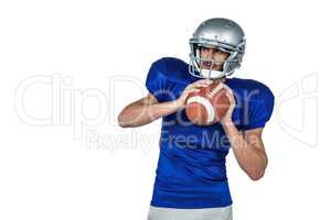 American football player holding ball white looking away