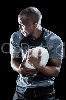 Rugby player looking away while catching ball