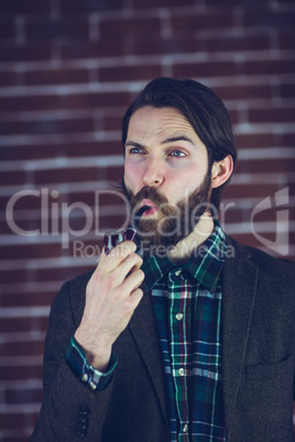 Handsome man looking away with smoking pipe