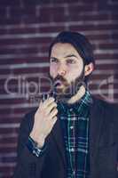 Handsome man looking away with smoking pipe