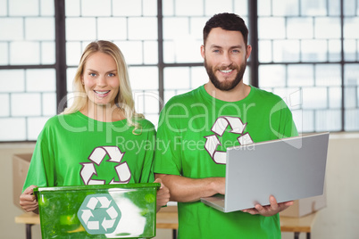 Portrait of smiling volunteers in recycling symbol tshirts