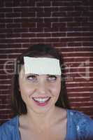 Pretty brunette with paper on head