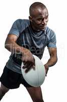 Confident athlete throwing rugby ball