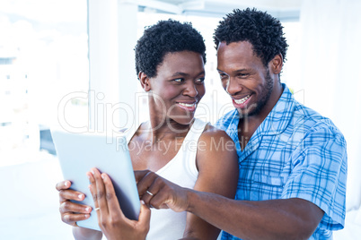Husband pointing towards digital tablet at home