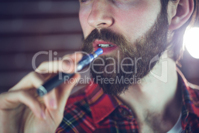 Handsome man holding electronic cigarette