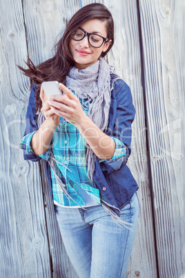 Happy hipster holding a mobile phone