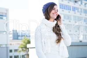 Brunette with warm clothes on the phone