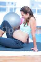 Pregnant woman relaxing in gym
