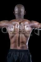 Rear view of shirtless muscular athlete