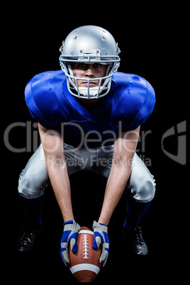 Portrait of American football player placing ball