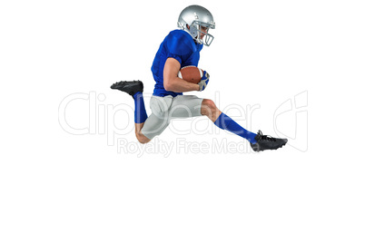 Full length of American football player running with ball