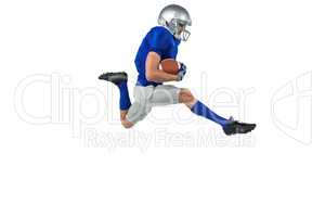 Full length of American football player running with ball