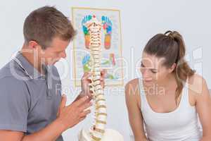 Doctor showing anatomical spine to his patient