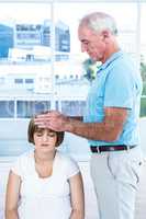 Male masseur massaging head of pregnant woman