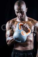 Muscular man exercising with kettlebell
