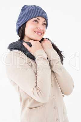 Attractive brunette looking up wearing warm clothes