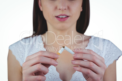 Woman snapping cigarette in half