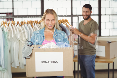 Woman holding donation box in creative office