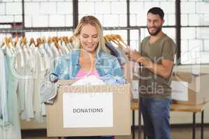 Woman holding donation box in creative office