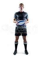 Serious rugby player in black jersey holding ball