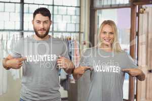 Man and woman showing volunteer text on tshirts