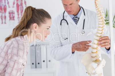 Doctor explaining anatomical spine to his patient