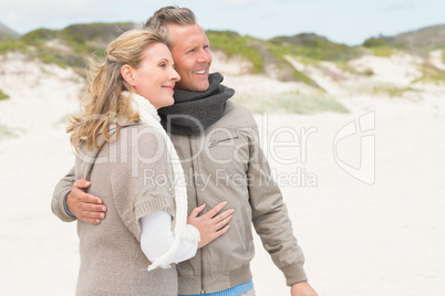 Happy couple embracing by the shore