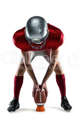 Full length of sports player placing the ball between his legs