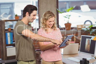 Business people looking at digital tablet in office