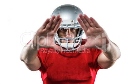 American football player in red jersey defending
