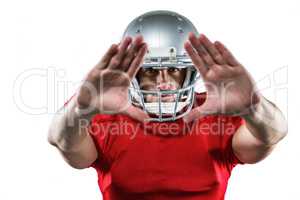 American football player in red jersey defending