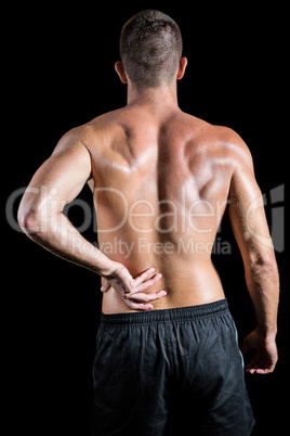 Shirtless athlete with back pain