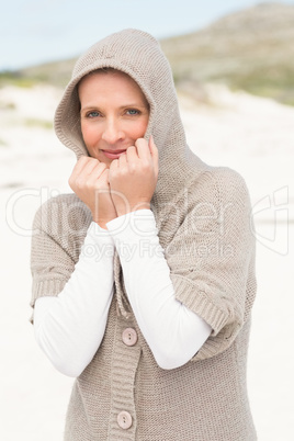 Smiling woman standing on the sand