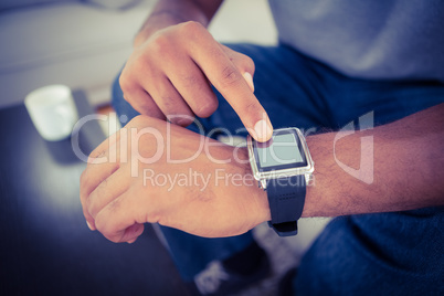 Close-up of man using smart watch