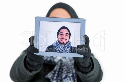 Bearded man using a tablet to take a selfie