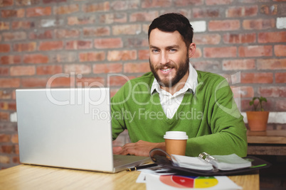 Portrait of smiling businessman working in office