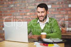 Portrait of smiling businessman working in office