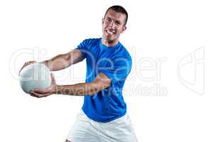 Portrait of smiling rugby player in blue jersey holding ball