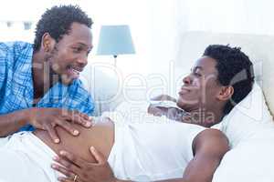 Man touching pregnant woman tummy