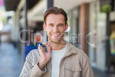 Portrait of a smiling man with shopping bags