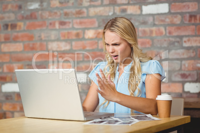 Frustrated businesswoman sitting in front of laptop