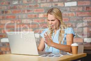 Frustrated businesswoman sitting in front of laptop