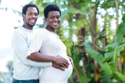 Portrait of happy man embracing wife while standing Portrait of happy man embracing wife while standing