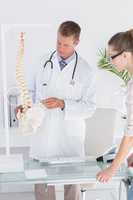 Doctor explaining anatomical spine to his patient