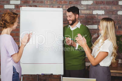 Women clapping for male colleague