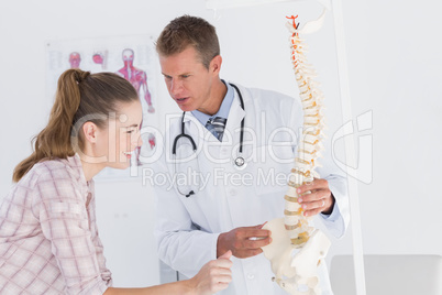 Doctor explaining anatomical spine to his patient