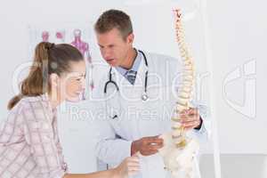 Doctor explaining anatomical spine to his patient