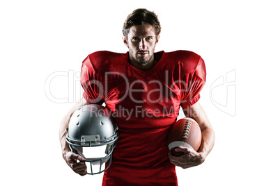 Confident American football player in red jersey holding helmet