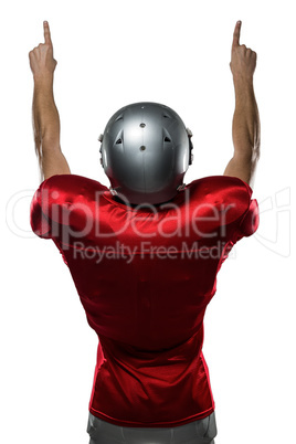 Rear view of American football player with arms raised