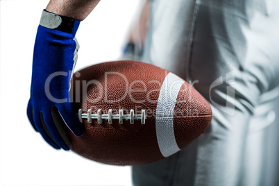 Cropped image of sportsman holding American football ball ball